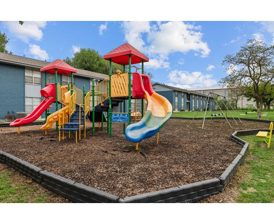 a playground at the whispering winds apartments in pearland, tx at Sunset Heights, San Antonio, TX
